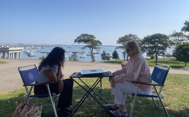 Caregiver and client spending time together outdoors near Plymouth harbor